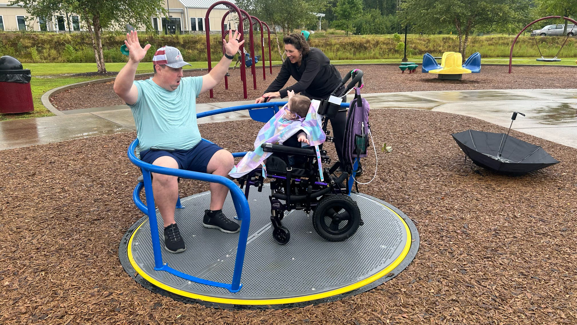 family on a wheelchair accessible merry go round